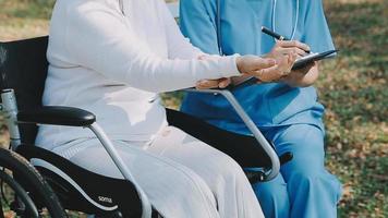 young asian physical therapist working with senior woman on walking with a walker video