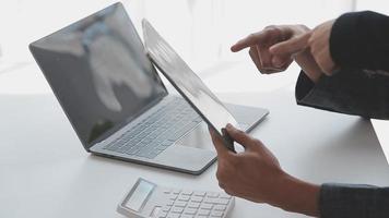 Financial analysts analyze business financial reports on a digital tablet planning investment project during a discussion at a meeting of corporate showing the results of their successful teamwork. video