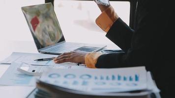 Financial analysts analyze business financial reports on a digital tablet planning investment project during a discussion at a meeting of corporate showing the results of their successful teamwork. video