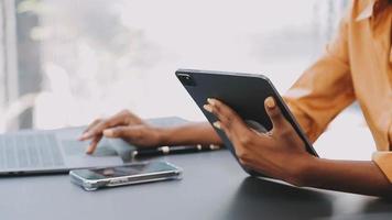 Financial analysts analyze business financial reports on a digital tablet planning investment project during a discussion at a meeting of corporate showing the results of their successful teamwork. video