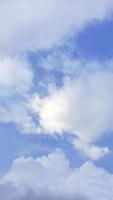 Fluffy white clouds in the soft blue sky, vertical image, sky wallpaper, nature background, backdrop, Pastel tone photo