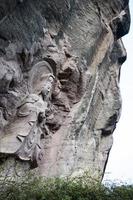 Statue of Avalokitesvara carved in a big rock photo