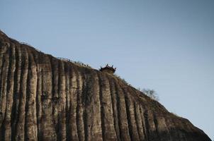 One side of a mountain which is almost 90 degree vertical photo