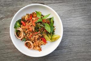 noodles plate with instant noodles stir fried with vegetables herb spicy tasty appetizing asian noodles mix seafood stir fried squid with basil and chilli pepper - top view photo