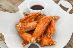 fried chicken wings with sauce thai food on wooden table food background photo