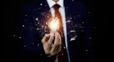 Innovative technology in science and communication concepts, and Creativity with glowing light bulbs.Hand hold light bulb with new idea concept with innovation, the new idea with energy and power photo