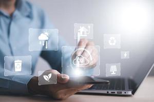 man hold Smartphone and global network connection with virtual modern reduce CO2 emission concept with icons, global warming emissions carbon footprint climate change to limit global warming, energy photo