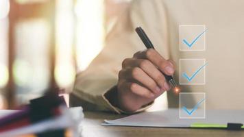 businessman check mark about exploring topics, In the virtual form check sheet,checklist ideas, checkbox ,Take an assessment, questionnaire, evaluation, document approval,online survey or test photo