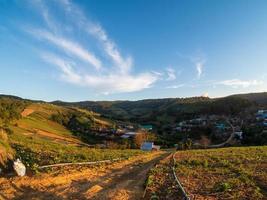 atmosphere long dirt road rural that travel through various village rural Thailand passing through forest meadows and mountain clear day blue sky white cloud in summer Suitable driving photo