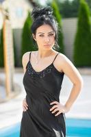 Attractive young lady dressed in a black dress photo