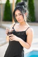 Nice young lady dressed in a black dress photo
