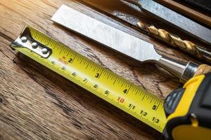 Tape measure with linear-measured markings on wooden background, DIY maker and woodworking concept. selective focus photo