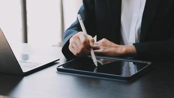 Financial analysts analyze business financial reports on a digital tablet planning investment project during a discussion at a meeting of corporate showing the results of their successful teamwork. video
