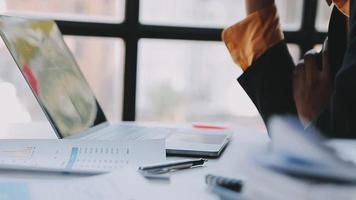 Financial analysts analyze business financial reports on a digital tablet planning investment project during a discussion at a meeting of corporate showing the results of their successful teamwork. video