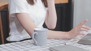 Asian Business woman using calculator and laptop for doing math finance on an office desk, tax, report, accounting, statistics, and analytical research concept video