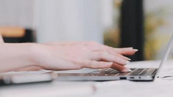 Asian Business woman using calculator and laptop for doing math finance on an office desk, tax, report, accounting, statistics, and analytical research concept video