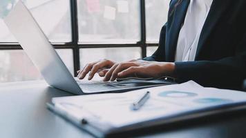 Financial analysts analyze business financial reports on a digital tablet planning investment project during a discussion at a meeting of corporate showing the results of their successful teamwork. video