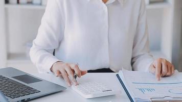 Financial analysts analyze business financial reports on a digital tablet planning investment project during a discussion at a meeting of corporate showing the results of their successful teamwork. video