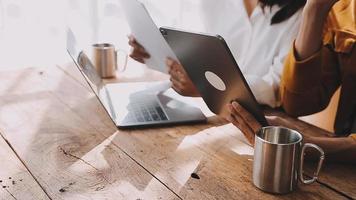 Financial analysts analyze business financial reports on a digital tablet planning investment project during a discussion at a meeting of corporate showing the results of their successful teamwork. video