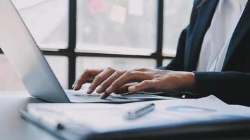 Financial analysts analyze business financial reports on a digital tablet planning investment project during a discussion at a meeting of corporate showing the results of their successful teamwork. video