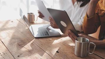 Financial analysts analyze business financial reports on a digital tablet planning investment project during a discussion at a meeting of corporate showing the results of their successful teamwork. video