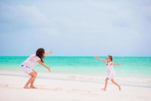 Mom and daughter having fun on the beach photo