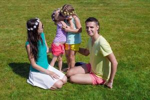 Happy family on the grass photo