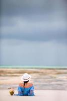 Woman in blue dress laying on the beach photo