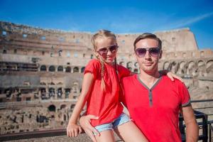 Father and daughter in front of the Colosseum, Rome - Italy photo