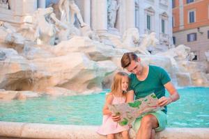Father and daughters in Trevi Fountain, Rome, Italy photo