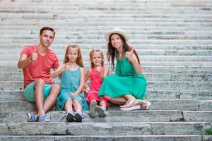 Family vacation. Beautiful family sitting on the stairs photo