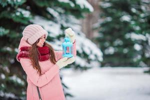 Woman holding lamp in the snow photo