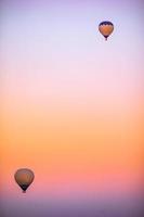 Hot air balloon flying over rocky landscapes in Cappadocia with beautiful sky on background photo