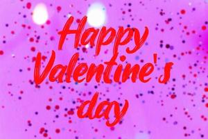 Happy Valentine's Day text on bokeh and confetti background photo