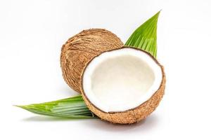 Coconut with half and leaves on white background photo