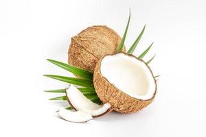 Coconut with half and leaves on white background photo