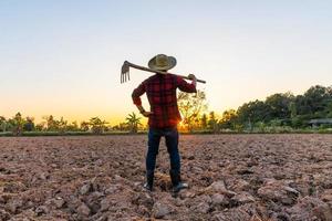 Farmer working on field at sunset outdoor photo