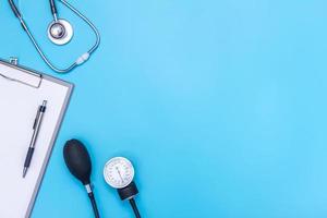 stethoscope and clipboard isolated on blue background photo