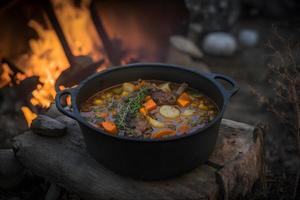 Delicious and hot hunters stew on bonfire food photography photo