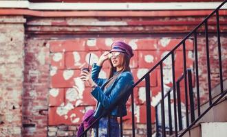 woman wearing cute trendy outfit, drinking hot latte photo