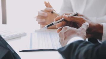 Financial analysts analyze business financial reports on a digital tablet planning investment project during a discussion at a meeting of corporate showing the results of their successful teamwork. video