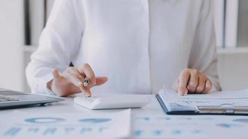 Financial analysts analyze business financial reports on a digital tablet planning investment project during a discussion at a meeting of corporate showing the results of their successful teamwork. video