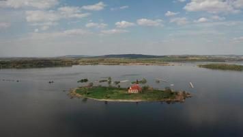 Aerial view of St. Linhart church on island in lake video