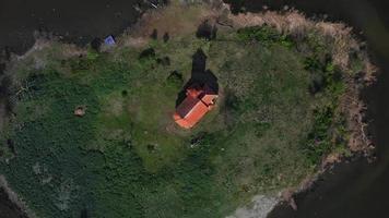 Aerial top down view of St. Linhart church on island in Nove Mlyny lake video