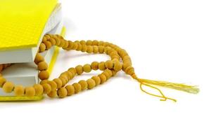 chanting book and wooden rosary beads photo