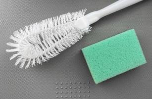 Brush and sponge for washing dishes. Household items for cleaning. photo