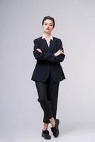 Attractive business young woman posing in business black suit with short photo