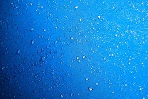 Water drops on the blue fabric.water drops on blue background photo