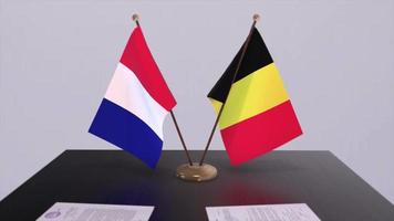 Belgium and France national flags on table in diplomatic conference room. Politics deal agreement video