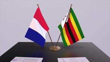 Zimbabwe and France national flags on table in diplomatic conference room. Politics deal agreement video